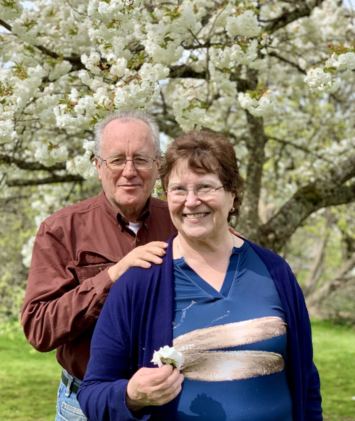 Dave and Barb under a flowering tree, spring 2025